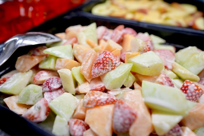 Fruit salad with strawberries, honeydew and cantaloupe on the buffet
